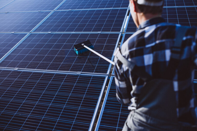 man worker in the firld by the solar panels
